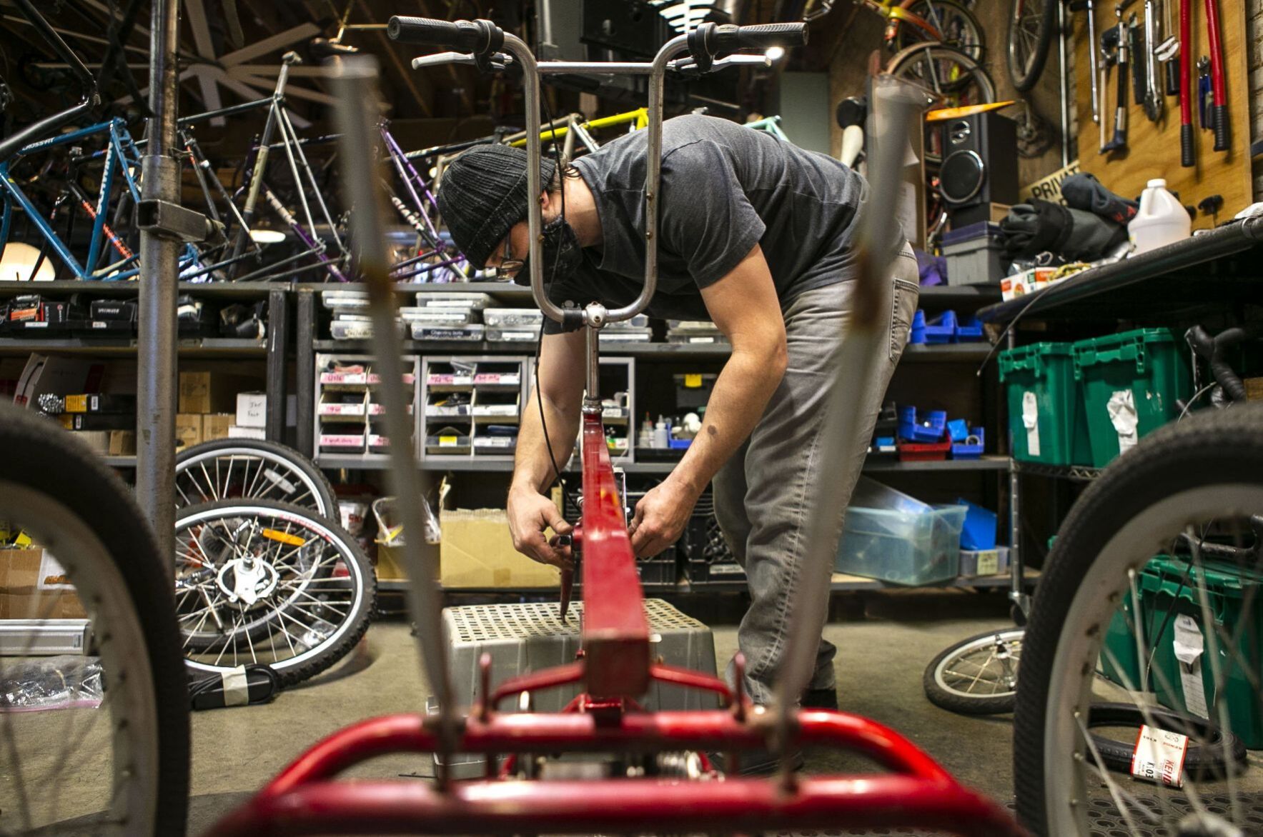 Volunteers and employees repair bikes at St. Louis BWorks in Soulard